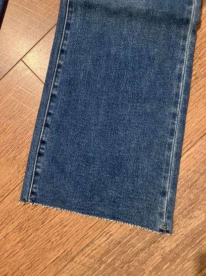 Plus size blue denim bootcut jeans with raw hem detail