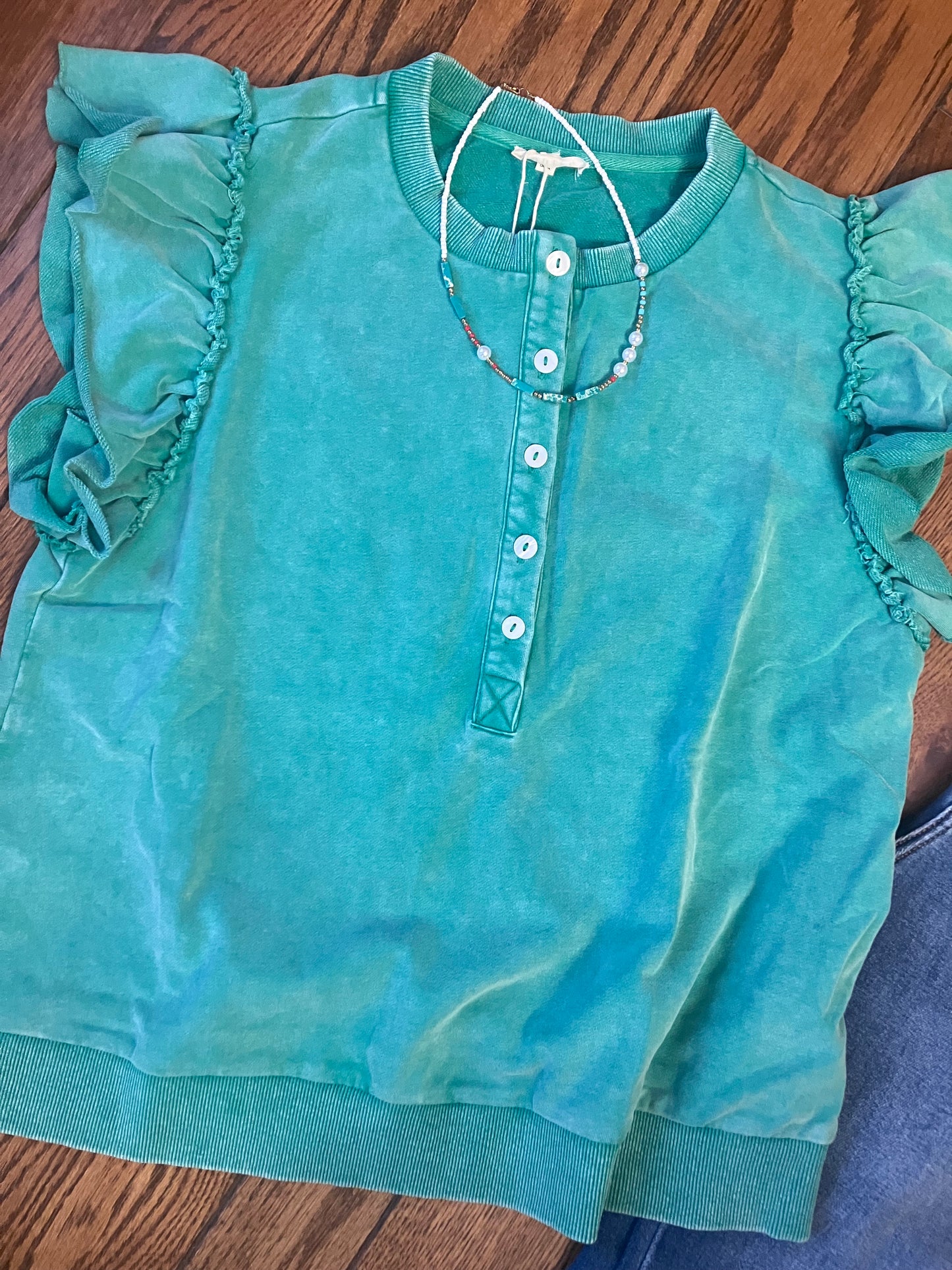 Farm Wife Threads: Flutter Green top with flutter sleeves, button front, and raw cut sleeve edges in green.